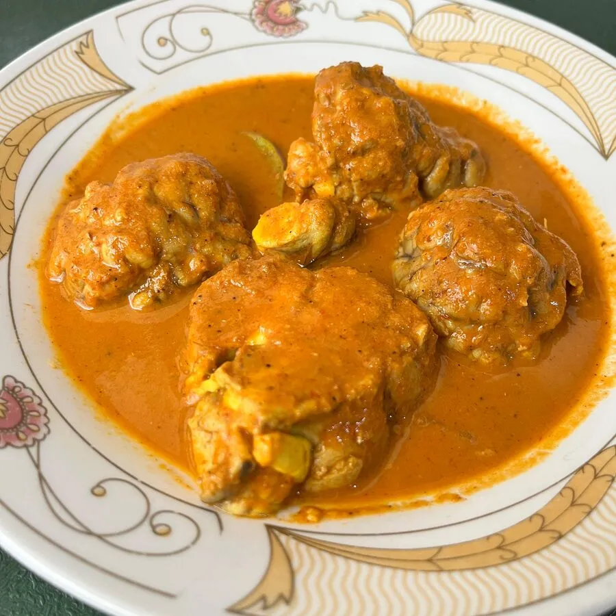 Gulai ayam — Minang chicken curry on a patterned plate